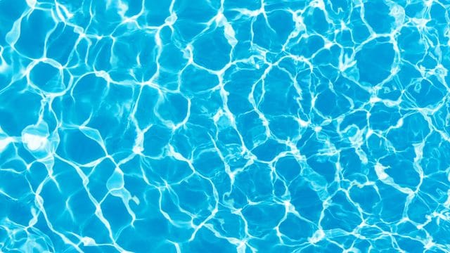 Empty rubber ring floating on blue water surface